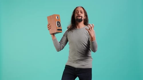 Man Dancing with Speaker on Blue Background