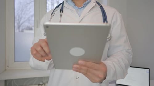 Frontal View of Doctor Using Tablet