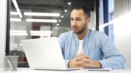 Man Talking on Video Call in Modern Office