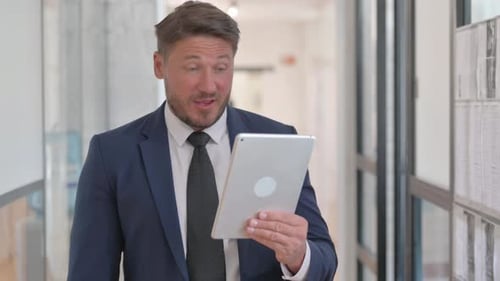 Adult Man Having a Video Call on Tablet