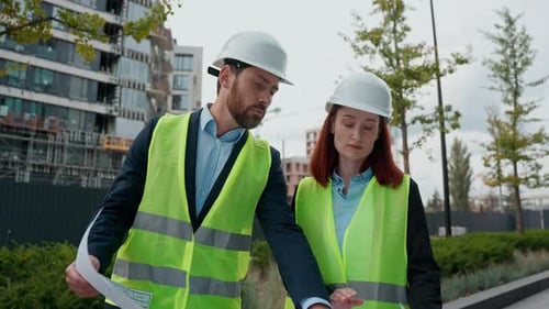Contractors Two Engineers Man Woman Talking Looking at Blueprint Building Plan Diversity People