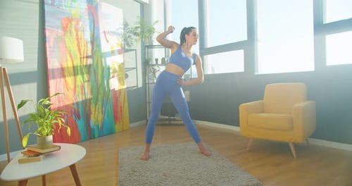 Young Woman Doing Side Stretches in Living Room