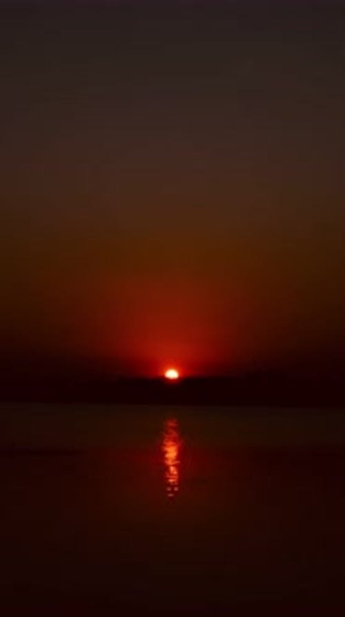Picturesque Sunset Over Calm Water at Golden Hour