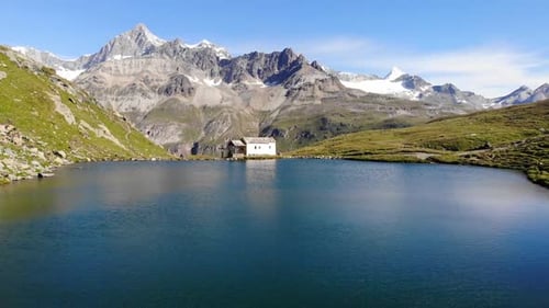 Scenic view of calm lake by rocky mountains during daytime