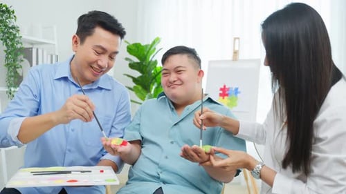 Happy People Painting Colorful Crafts Together Indoors