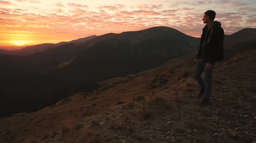 Ukrainian Young Man Traveler Walks Along the Most Beautiful High Mountain Road in Romania