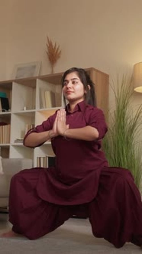 Woman Doing Yoga Squat in Living Room