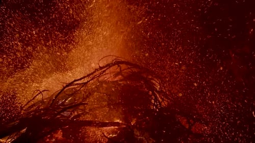 Burning Hot Ash and Ember Rise From Large Fire In The Night Sky