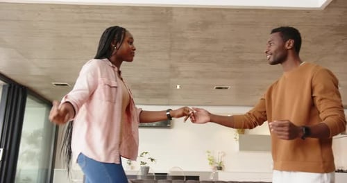 Joyful Couple Dancing Together in Modern Home