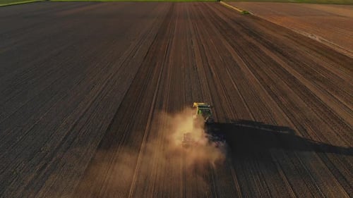 Tractor Plowing Field Aerial View on Sunny Day