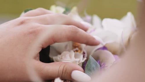 Woman Touches Fresh Flowers Bouquet on Store Display