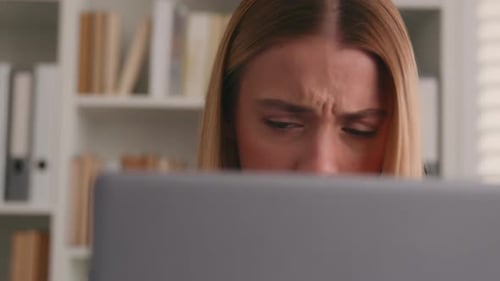 Concentrated Woman Working on Laptop in Office