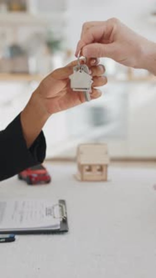 Realtor Handing Over Keys to New Home