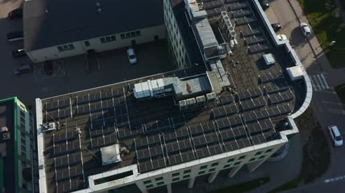 Rows of Solar Panels Installed on the Roof of an Industrial Building in the City