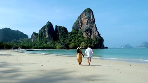 Couples Romantic Stroll Along the Pristine Beaches of Railay Krabi Thailand in Serene Sunlight