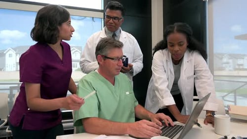 Doctors and Nurses Meeting at Laptop in Clinic 2529 Years