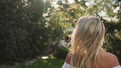 Portrait of a Caucasian Woman in Nature Near Green Trees