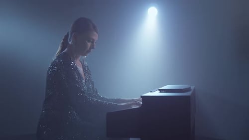 Elegant Woman Playing Piano on Stage