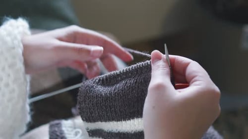 Close Up of Hands Knitting Wool Yarn