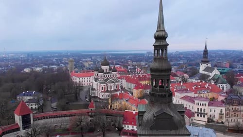 Forward moving aerial over Tallinn, Estonia, showing medieval old cityscape on overcast day.