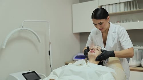 Woman Receiving Facial Massage in Clinic Room