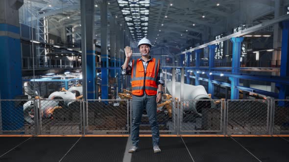 Asian Male Engineer Smiling And Waving Hand Saying Good Bye In Factory ...