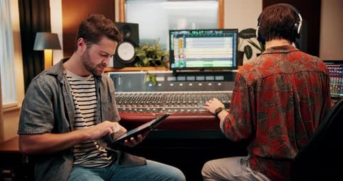 Production, tablet and producers in studio with music for working on album or song with computer