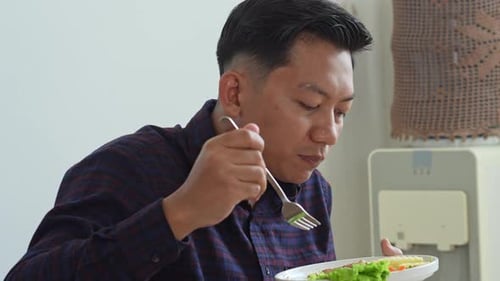 Man Eating Salad With Fork Indoors Daytime
