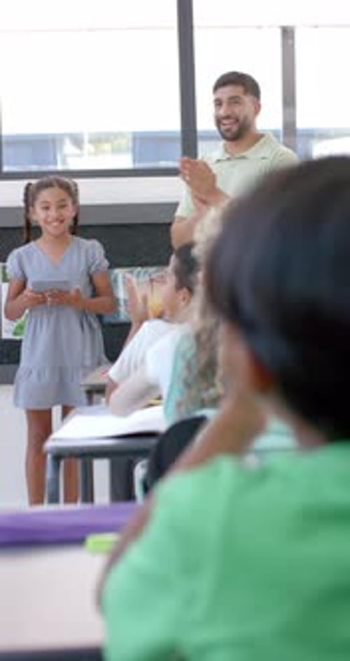 Vertical video: In school, young girl stands presenting to her class