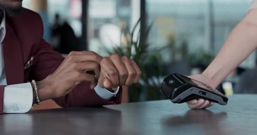 Closeup of a Man's Hand Paying with a Smart Watch for an Order at a Restaurant