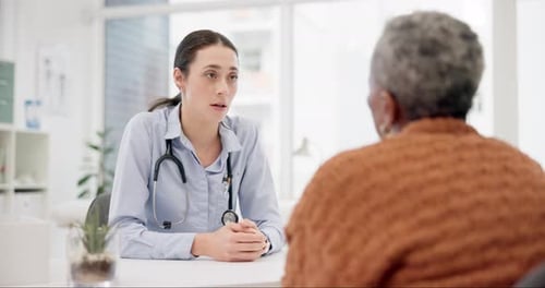 Young Woman Doctor Talking to a Senior Woman