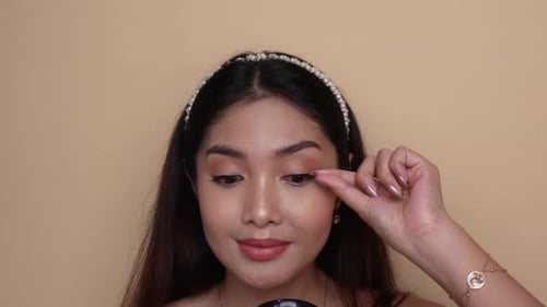 Woman Applies False Eyelashes for a Beauty Routine