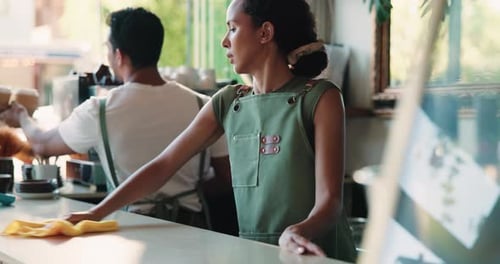 Cleaning, counter and waitress with cloth in cafe, hygiene and disinfection for restaurant health