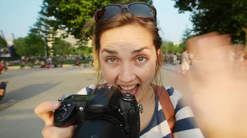 4k video footage of a young woman taking pictures with a camera while exploring a city