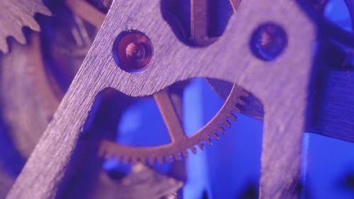 Clock Gears Rotating in Blue Light