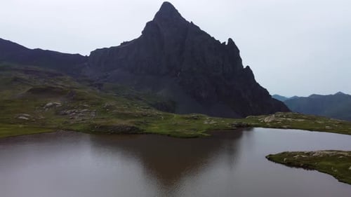 Mountain lake with a mountain background in summer