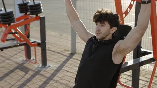 Man Working Out on Outdoor Weight Machine