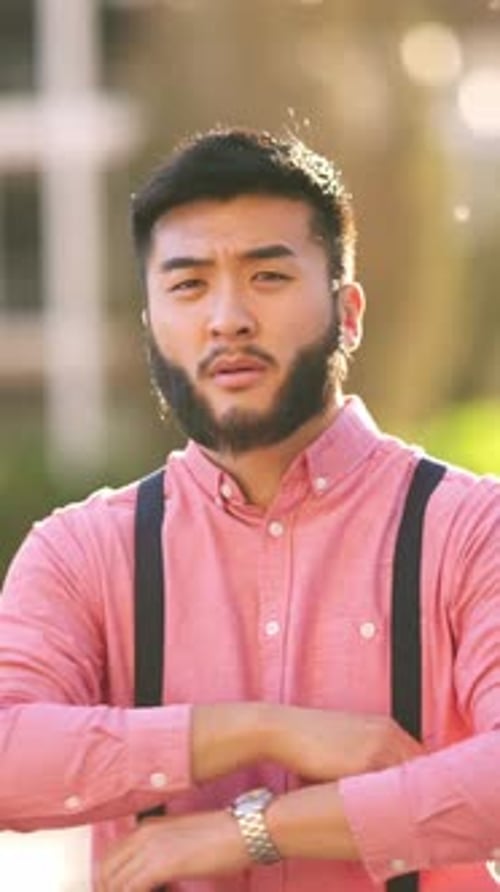 Asian Man Crossing His Arms with a Confident Attitude on the Street in a City