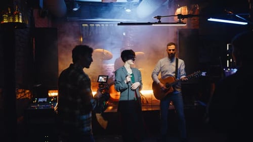 Energetic Music Band Performing on Nightclub Stage Talented Rock Performers
