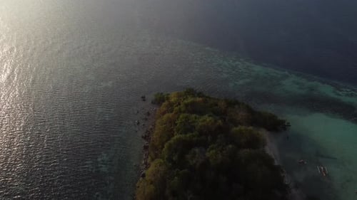 Aerial video over a small beach island, Coron Palawan, Philippines, at sunset
