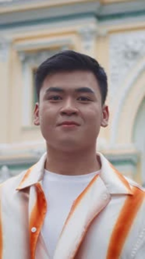 Portrait of Asian Gen Z Guy Walking at City Center