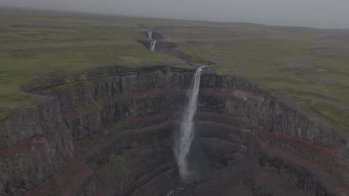 Majestic Waterfall in the Rugged Terrains of Iceland
