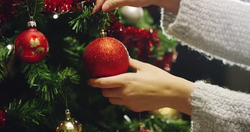 Decorating Christmas Tree with Festive Red Ornaments