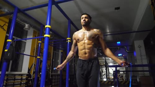 Strong African Athlete with Tattoos Skipping with a Jump Rope at Sport Club Young Black Sporty Man