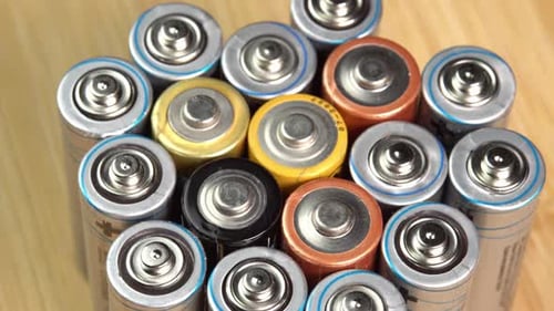 Rows of used alkaline AA batteries. Lithium ion battery pack close up. Electric power supply