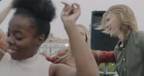 Young Adults Dancing on a City Rooftop
