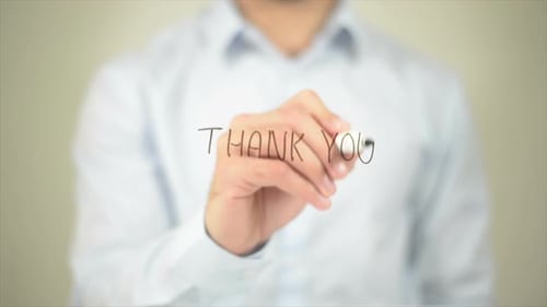 Man Writes Thank You on Transparent Surface