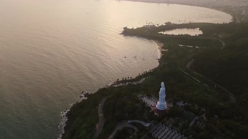 Aerial fly Lady Buddha Statue and Da Nang Coastline at Sunset, Vietnam landscape