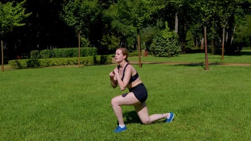 Active Motivated Sporty Fit Woman Performing Jumping Lunges Exercise in Park