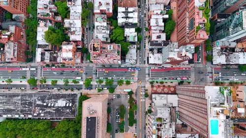 Flow of cars move by the multi-lane street at daytime.